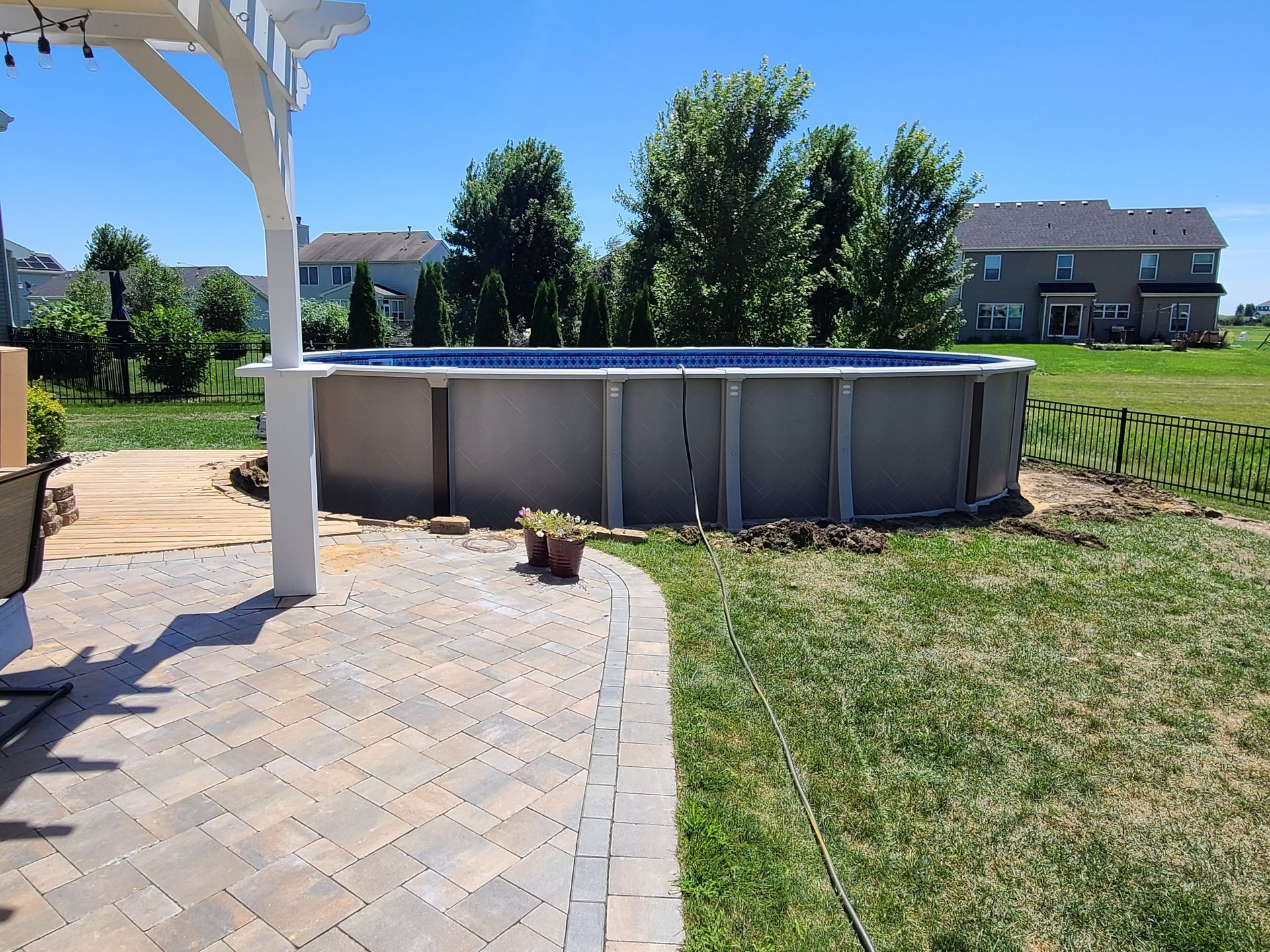 a swimming pool is being built in the backyard of a house .