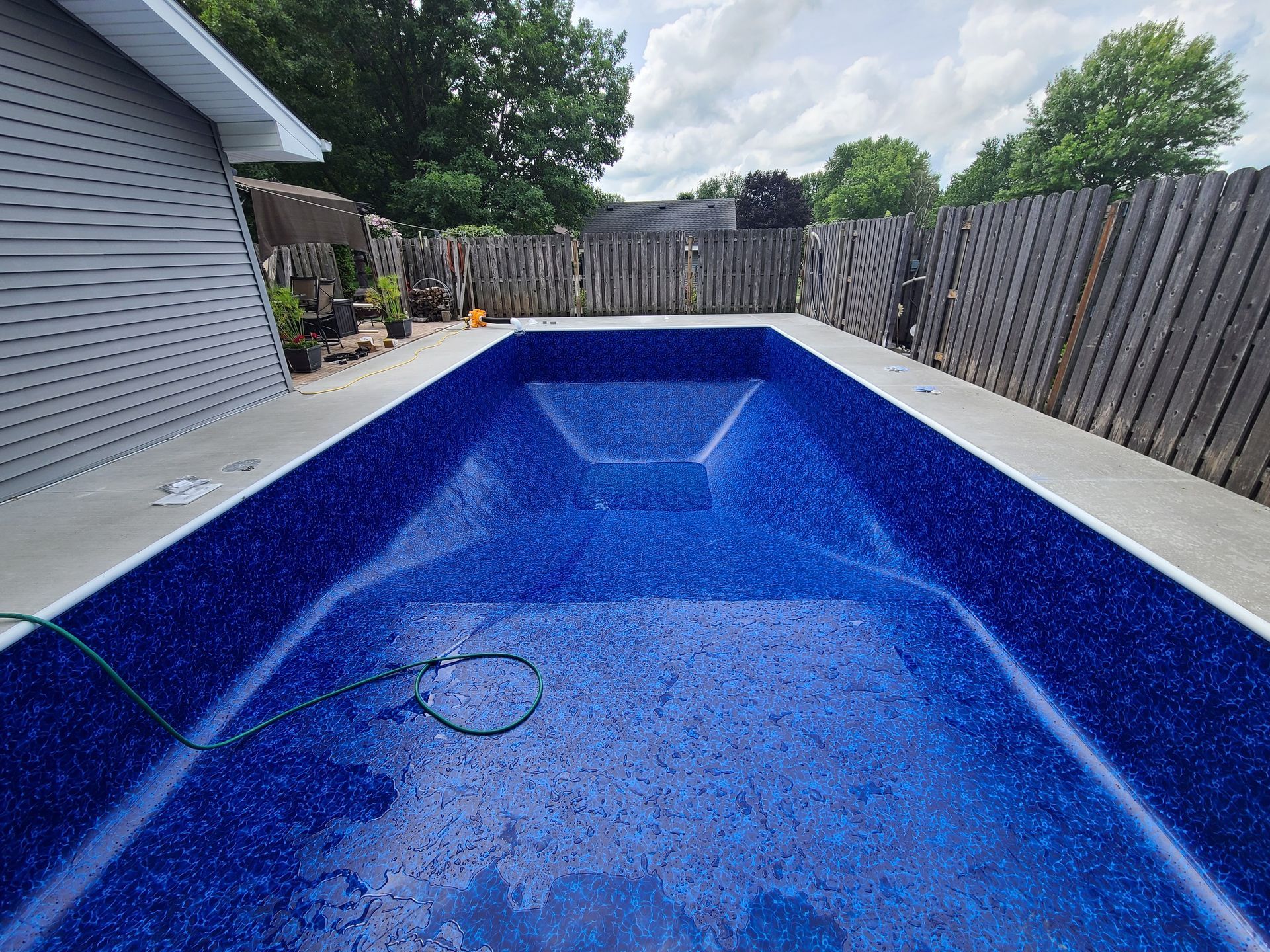 an inground pool being refilled
