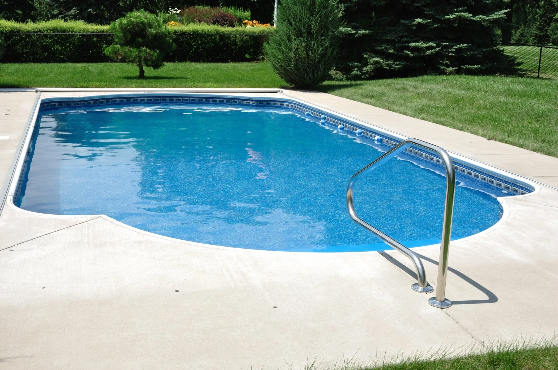 a swimming pool with a staircase leading to it