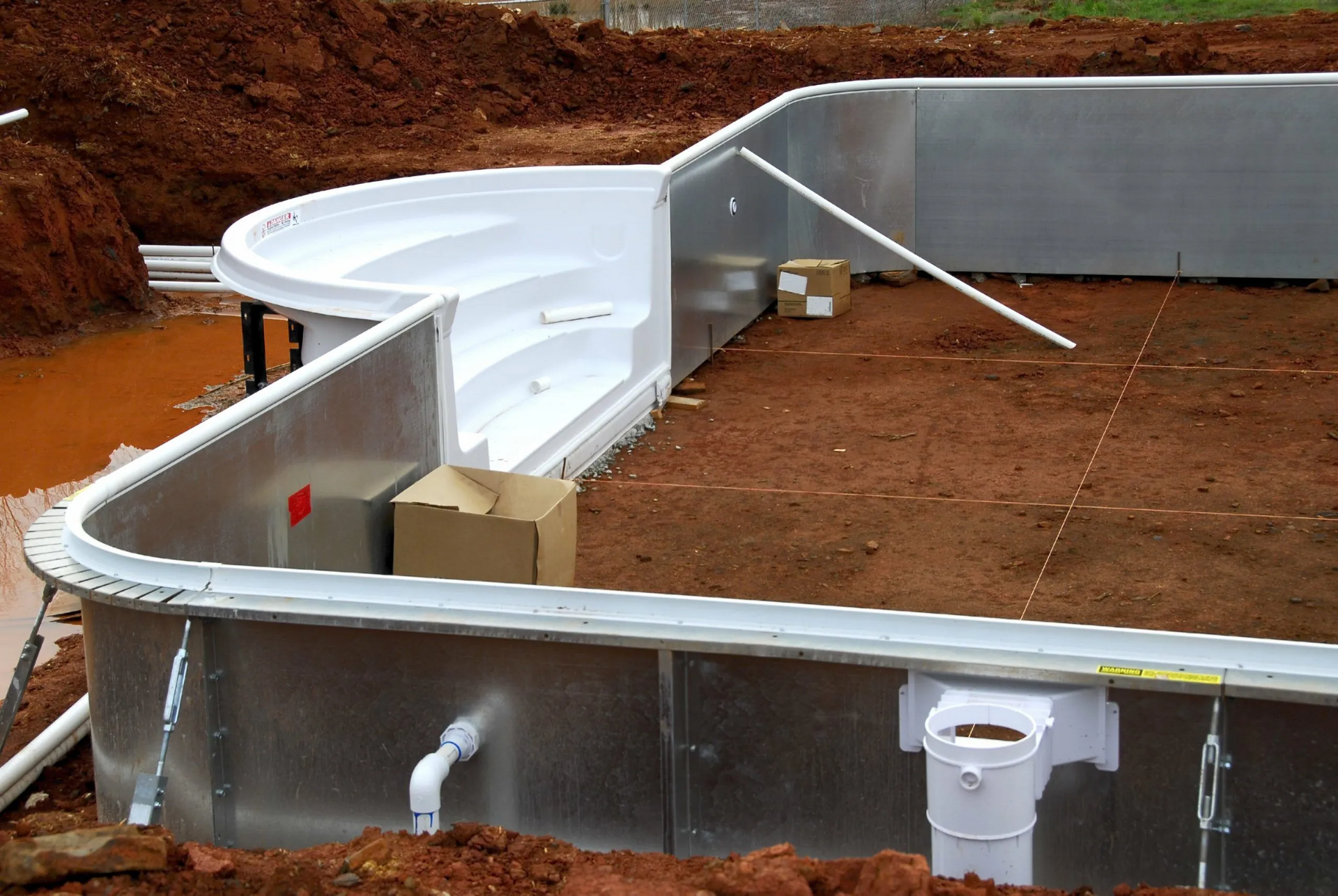 a swimming pool is being built in the dirt