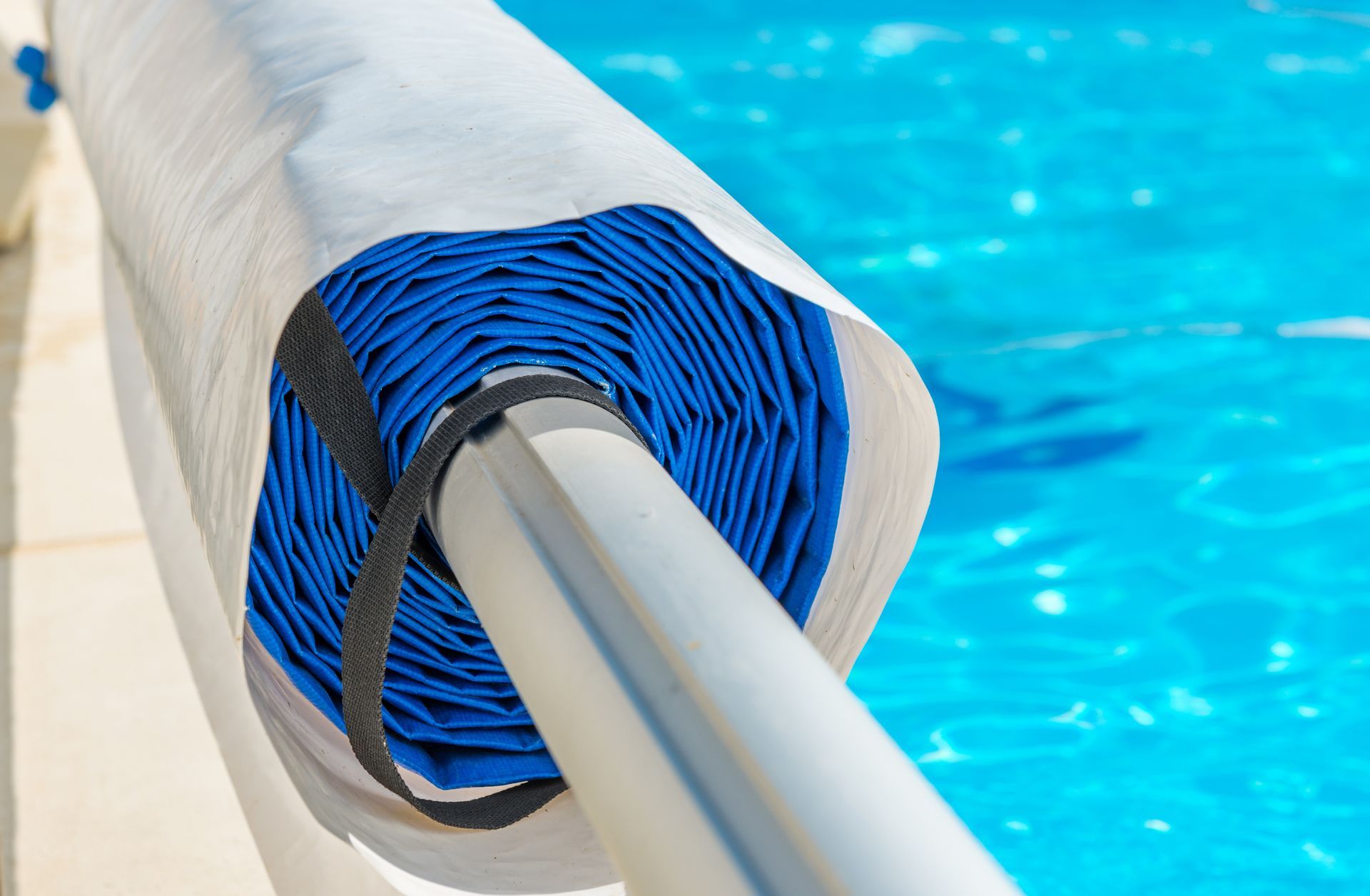 rolled up pool cover, pool open for the summer