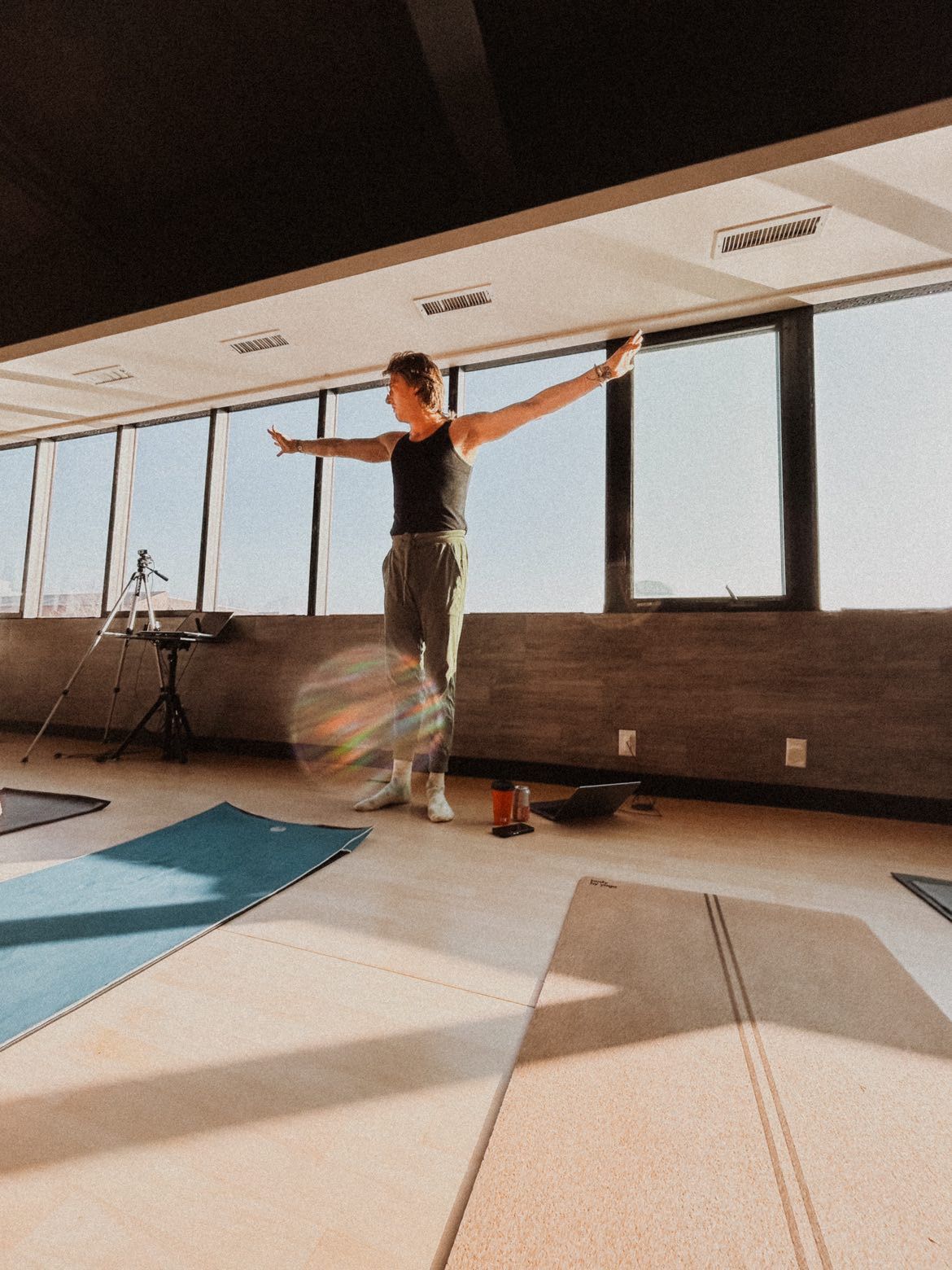 A woman is standing in a room with her arms outstretched.