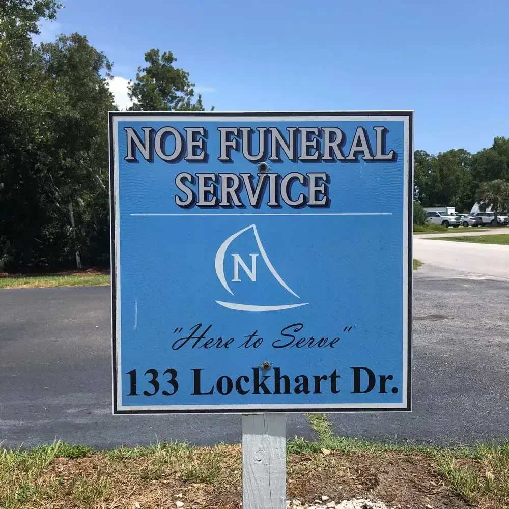 A blue sign that says noe funeral service on it