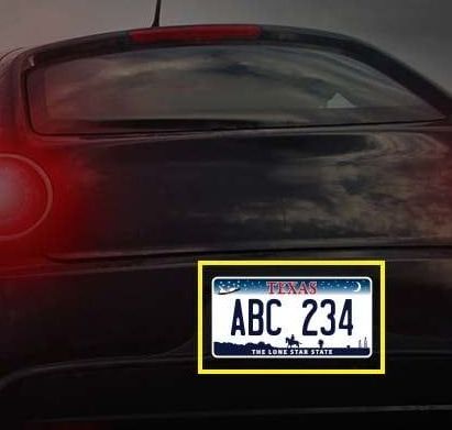 Texas license plate on the back of a black car, with the plate number ABC 234.