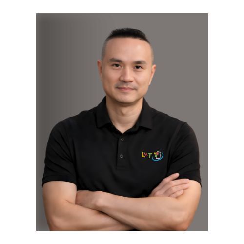 Asian man in a white shirt looking at the camera, set against a dark background.