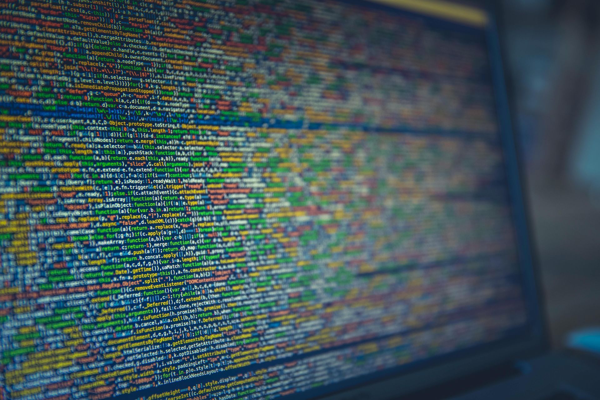 Close-up of a laptop screen displaying colorful lines of code.