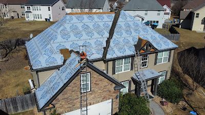 An aerial view of a house with a roof being installed.
