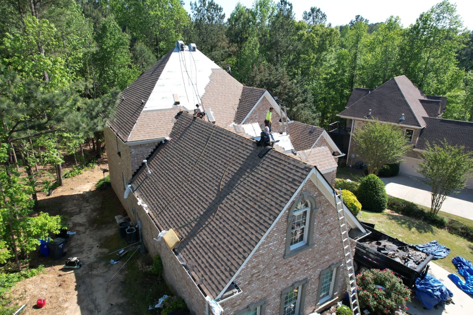An aerial view of a house with a roof being installed.