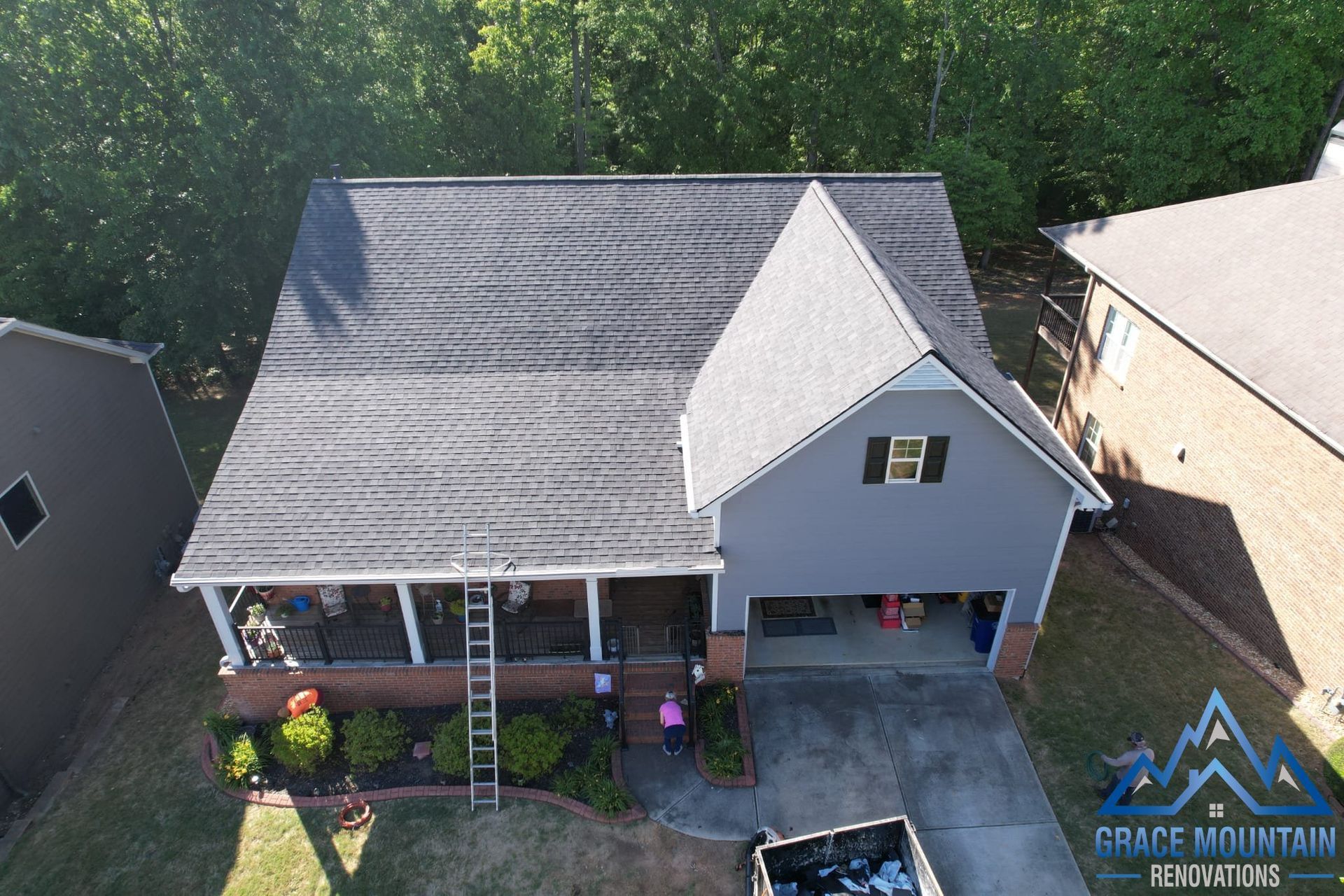 An aerial view of a house with a gray roof.