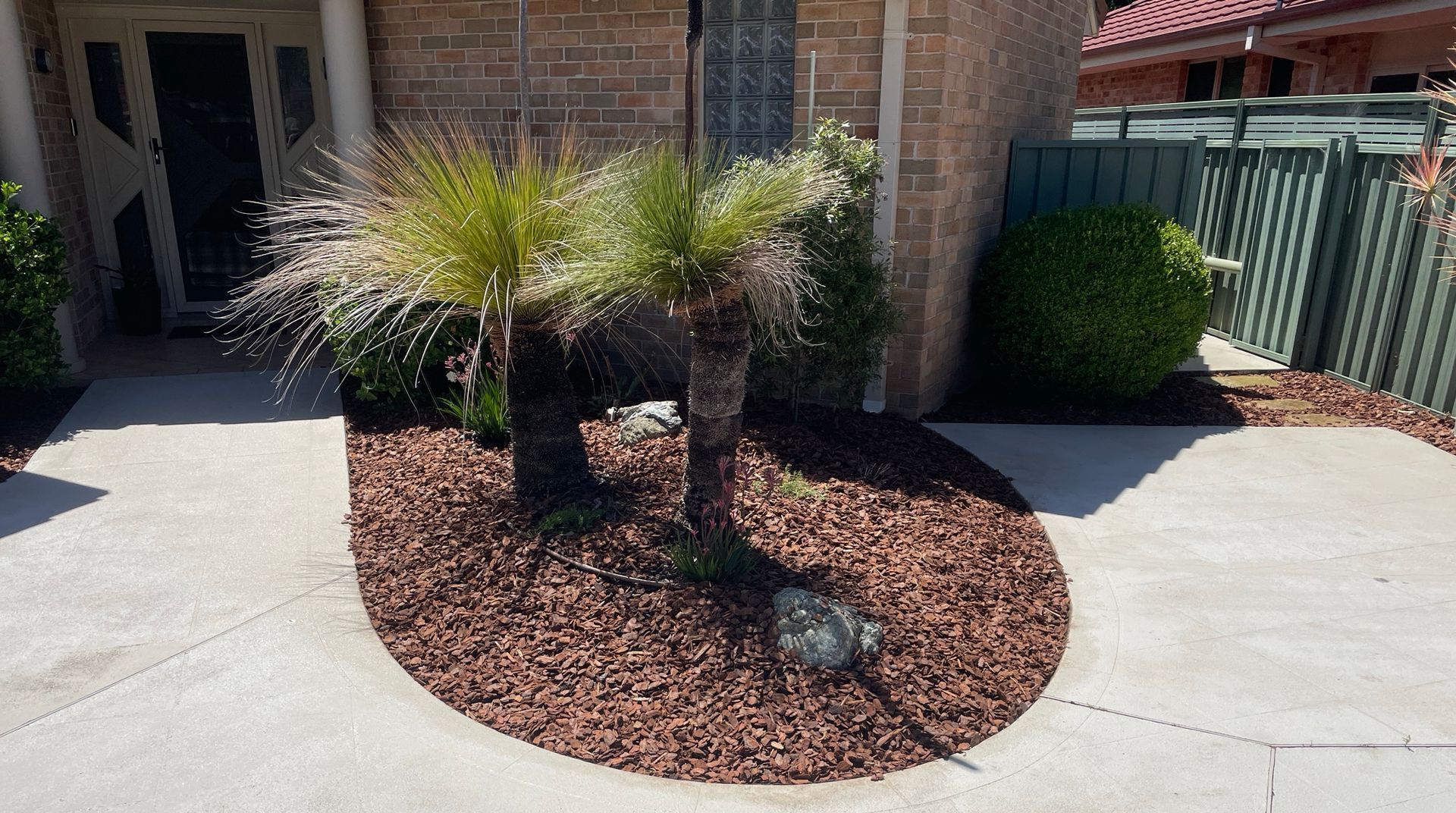 Nice garden bed with two trees. — Greener Gardens Gardening Service In Thrumster, NSW