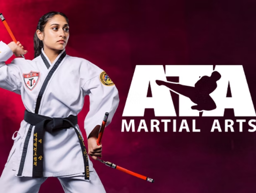 Woman in martial arts uniform, holding nunchucks, with