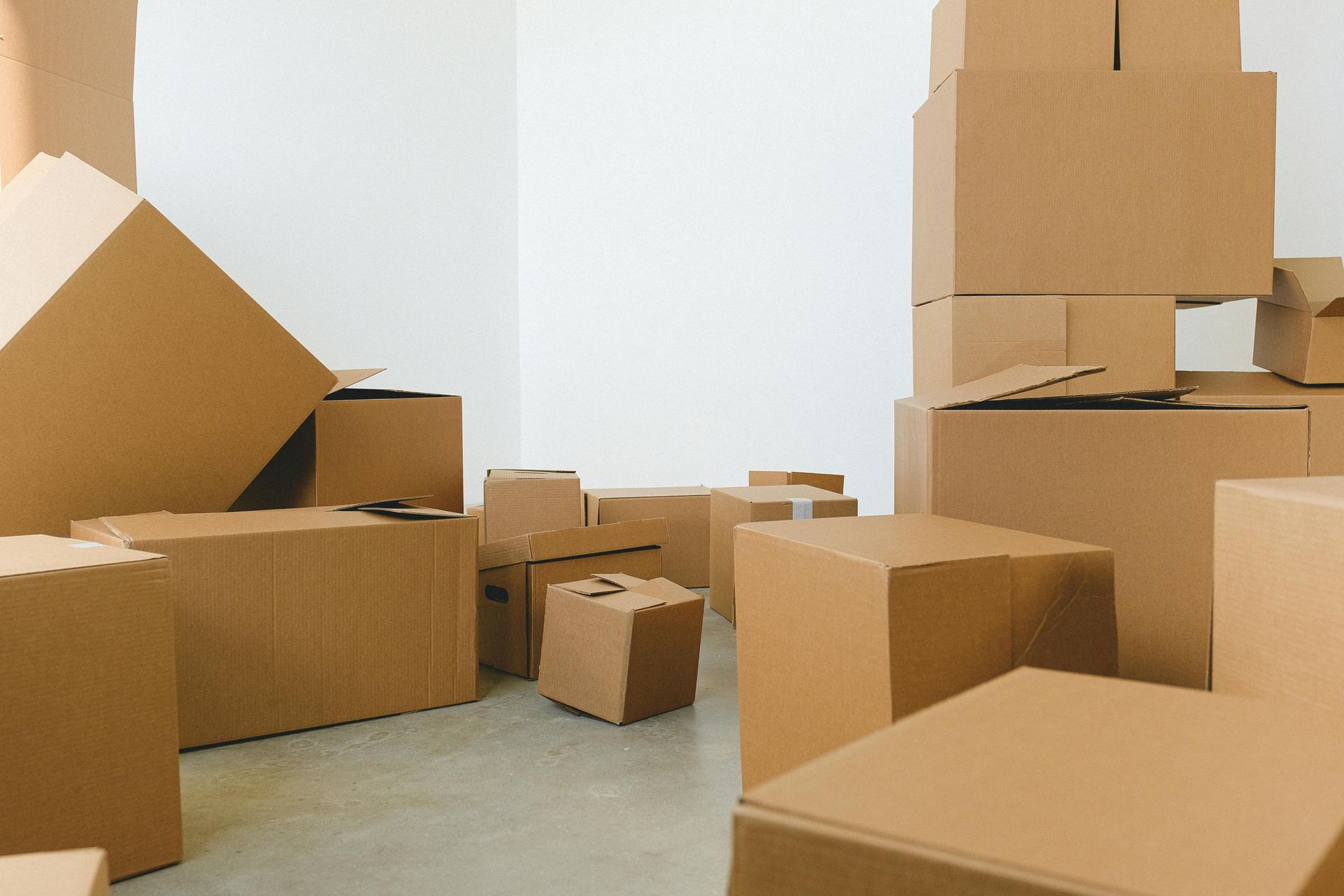 Cardboard boxes stacked in a room, possibly ready for moving.