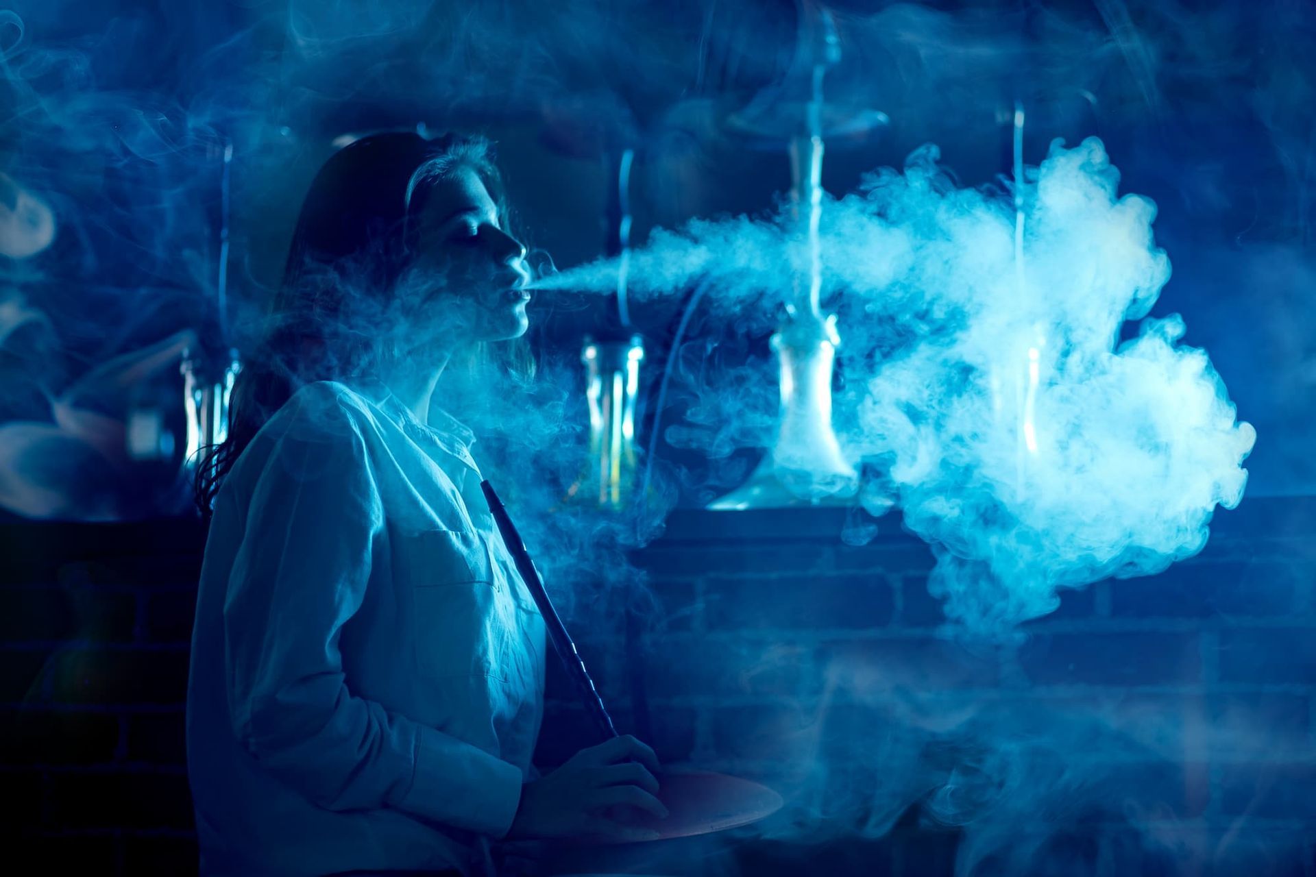 A Woman Smoking a Hookah — Mini Market Townsville Smoke Shop in Townsville City, QLD
