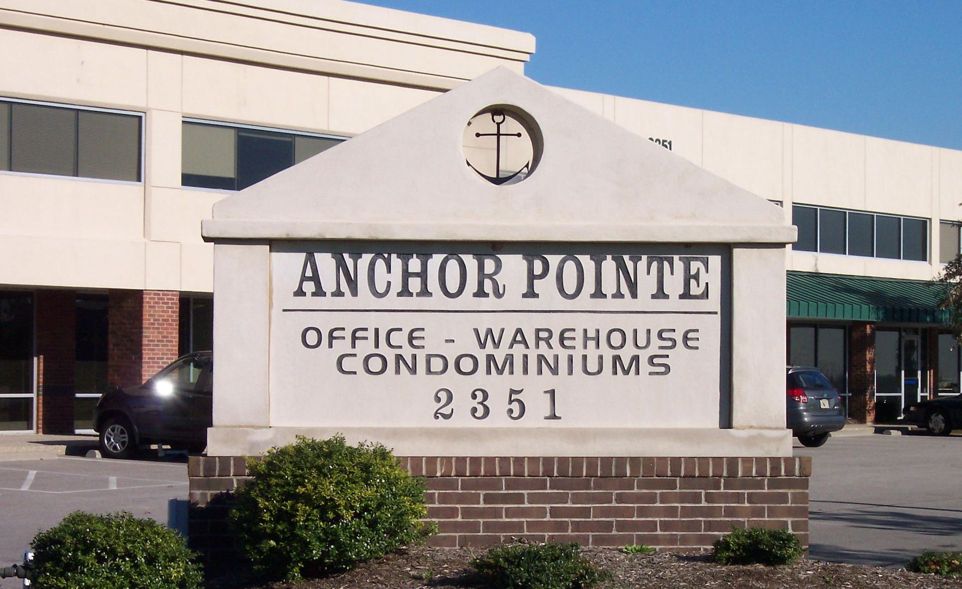 Anchor Pointe office-warehouse-condominiums sign in front of a beige commercial building.