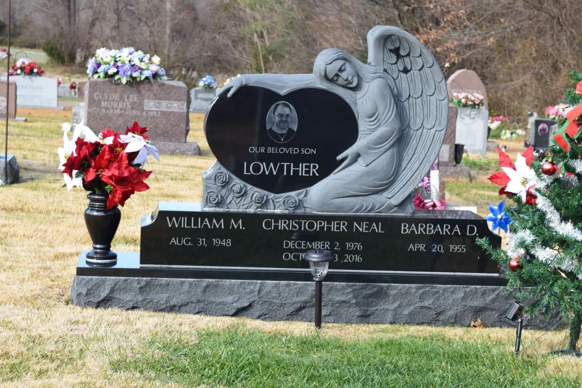 Black headstone with angel and roses in a cemetery, memorializing the Lowther family