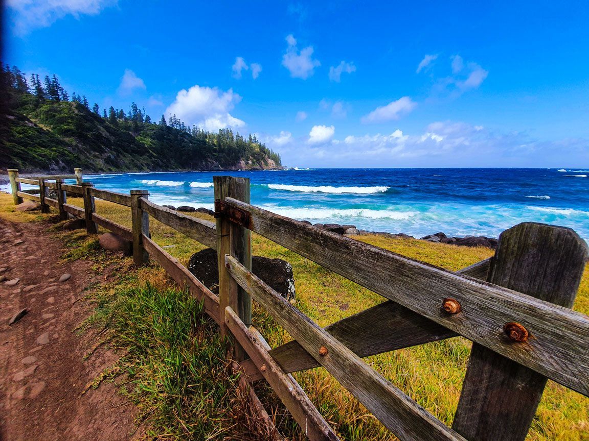 Wooden fence beside a sandy path with ocean view. Norfolk Island Trade Winds Seniors Sanctuary