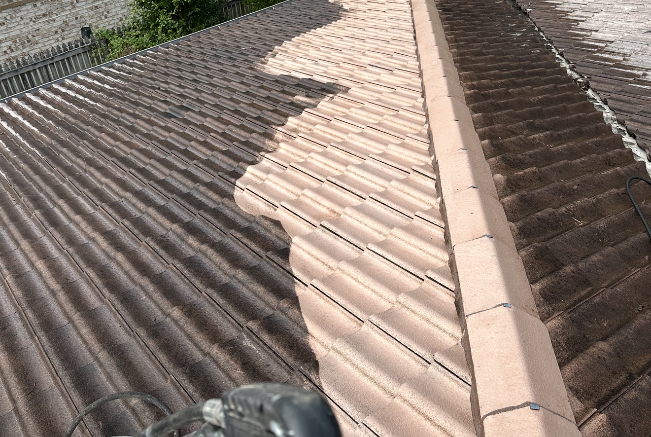 Roof cleaning in progress: half the roof is clean, light brown, the other half is dirty, dark brown — Roof Tek CQ in Gracemere, QLD
