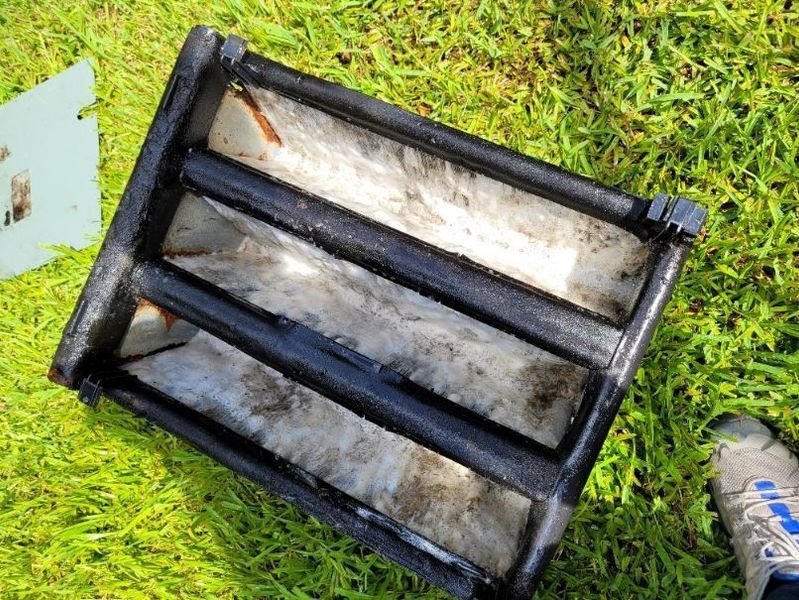 Black rectangular planter with three sections on green grass.