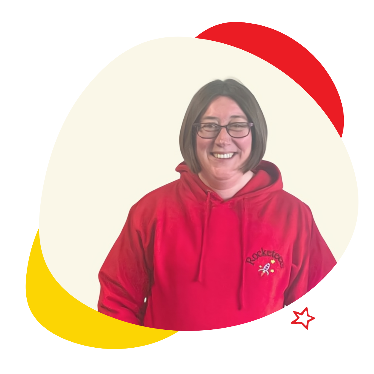 A woman wearing glasses and a red hoodie is smiling.