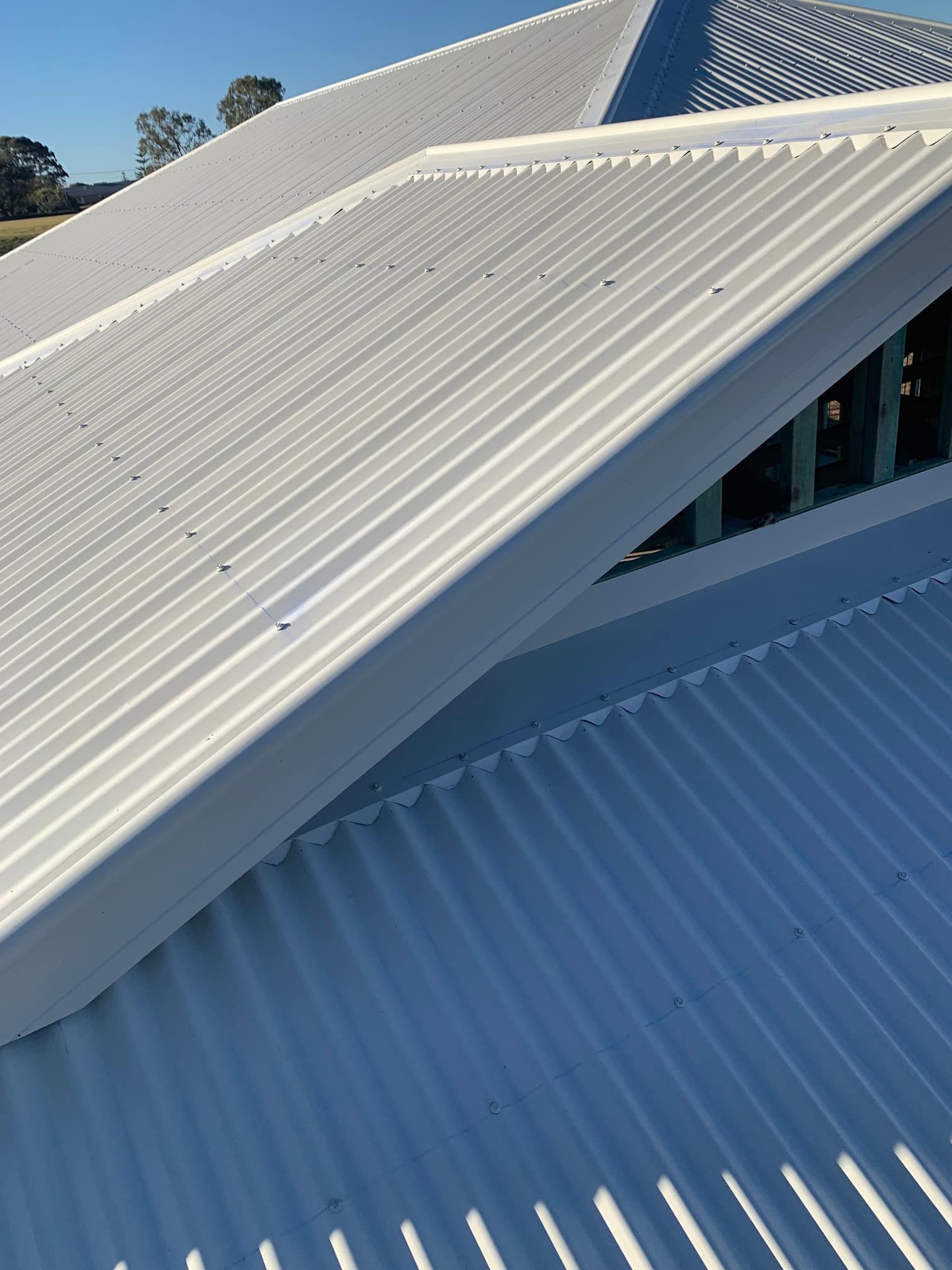 A close up of a white corrugated metal roof on a building.