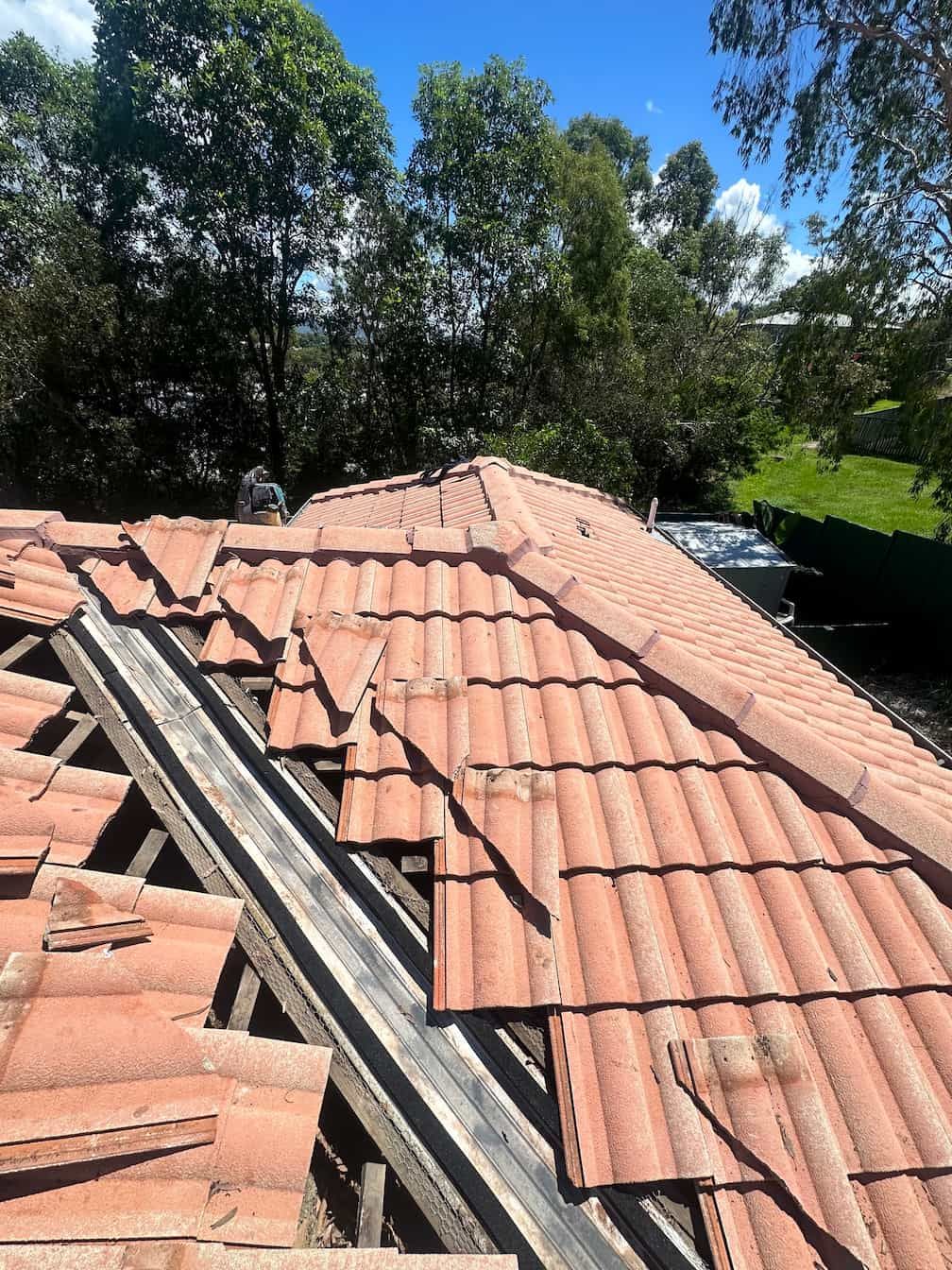 A Gold Coast roof with lots of tiles being repaired
