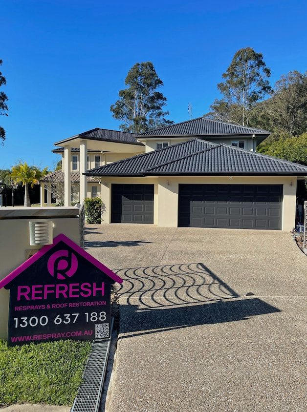 A house with a Refresh Roof & Exterior Restoration sign in front of it