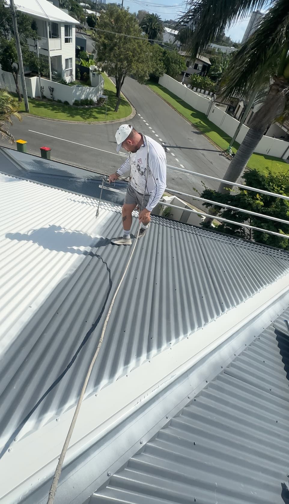 Reece from Refresh painting a roof in Currumbin.