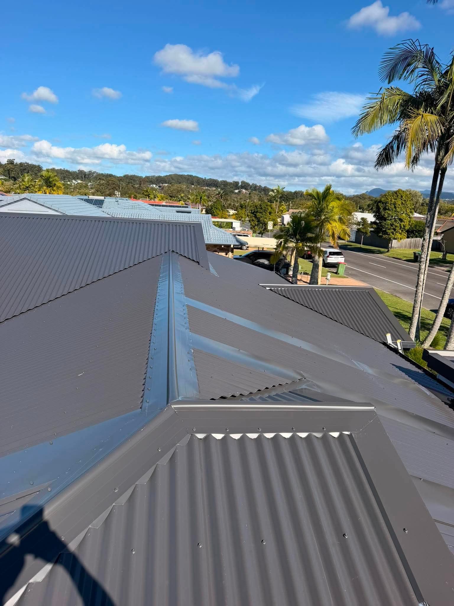 A person painting a roof in Mermaid Waters