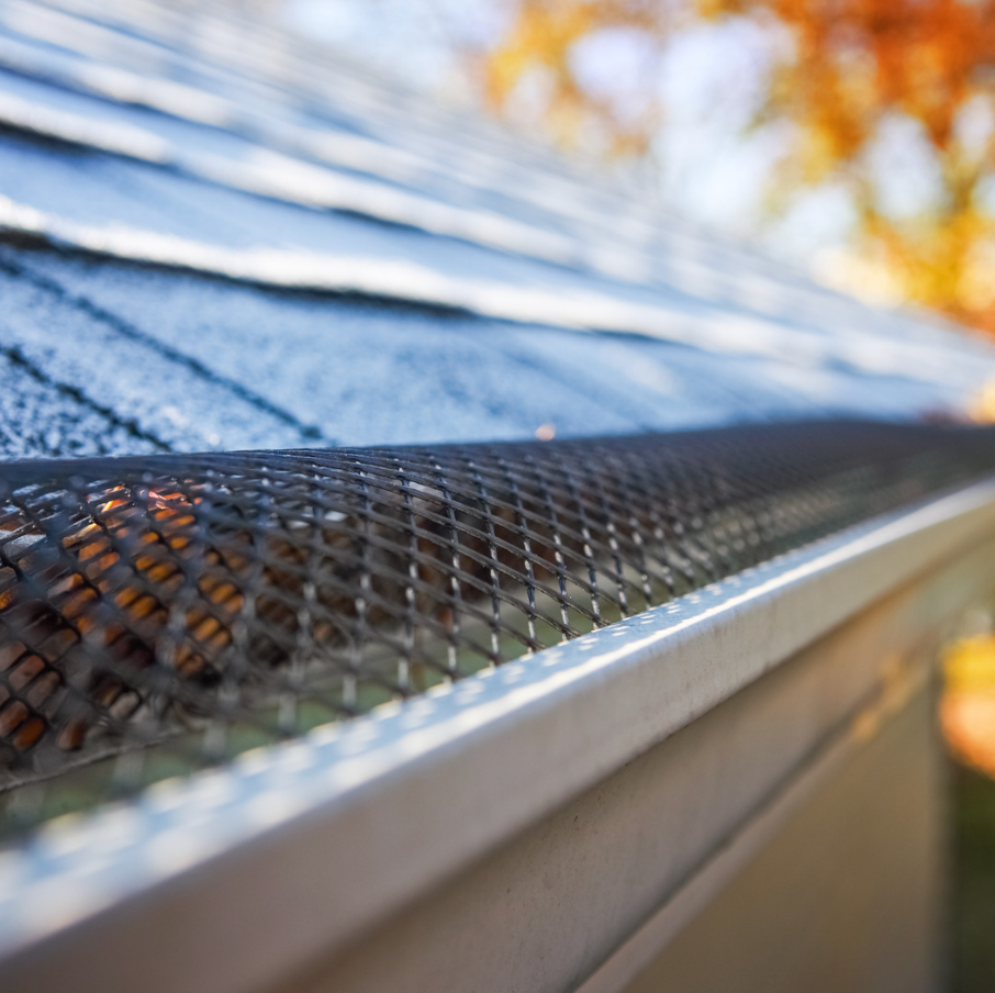 A close up of a gutter with a mesh on it.