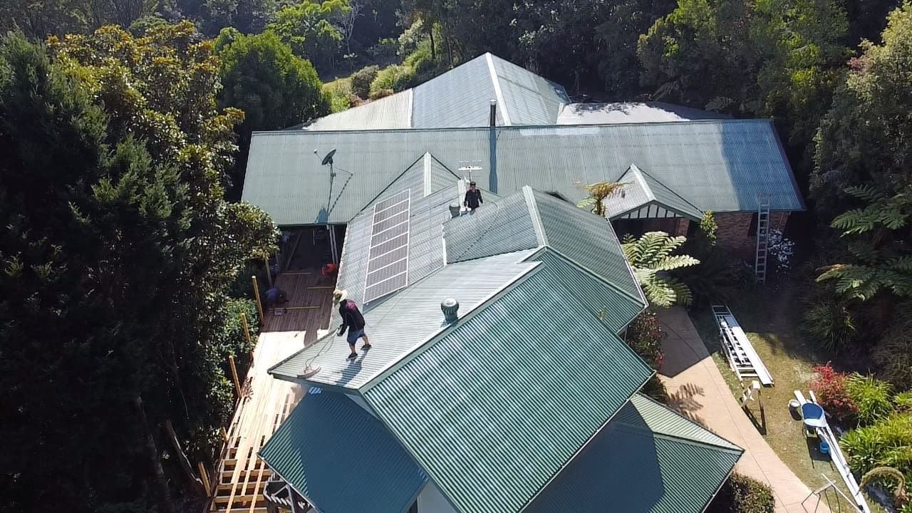 A drone shot of someone restoring a roof in Tugun QLD.