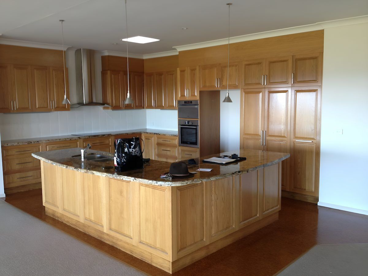A Kitchen With Wooden Cabinets And Granite Counter Tops — Alstonville Kitchens In Alstonville, NSW