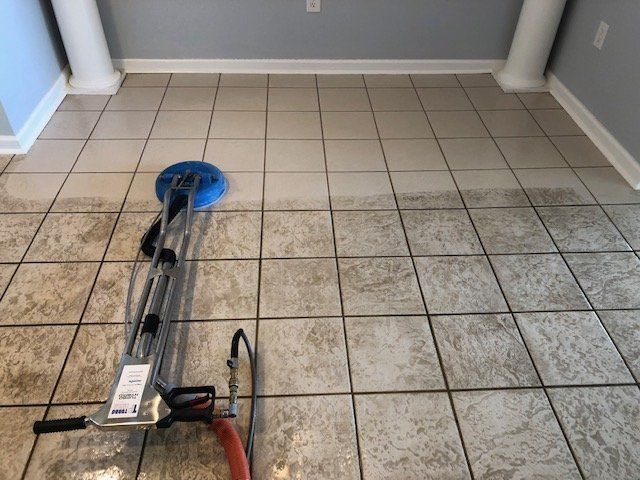 A tile floor is being cleaned with a machine