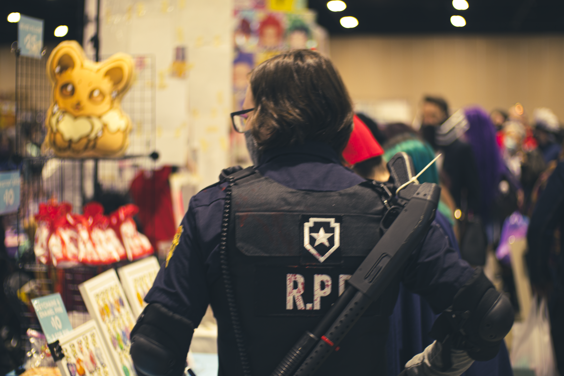 Person in a Resident Evil R.P.D. costume with a shotgun at a convention.