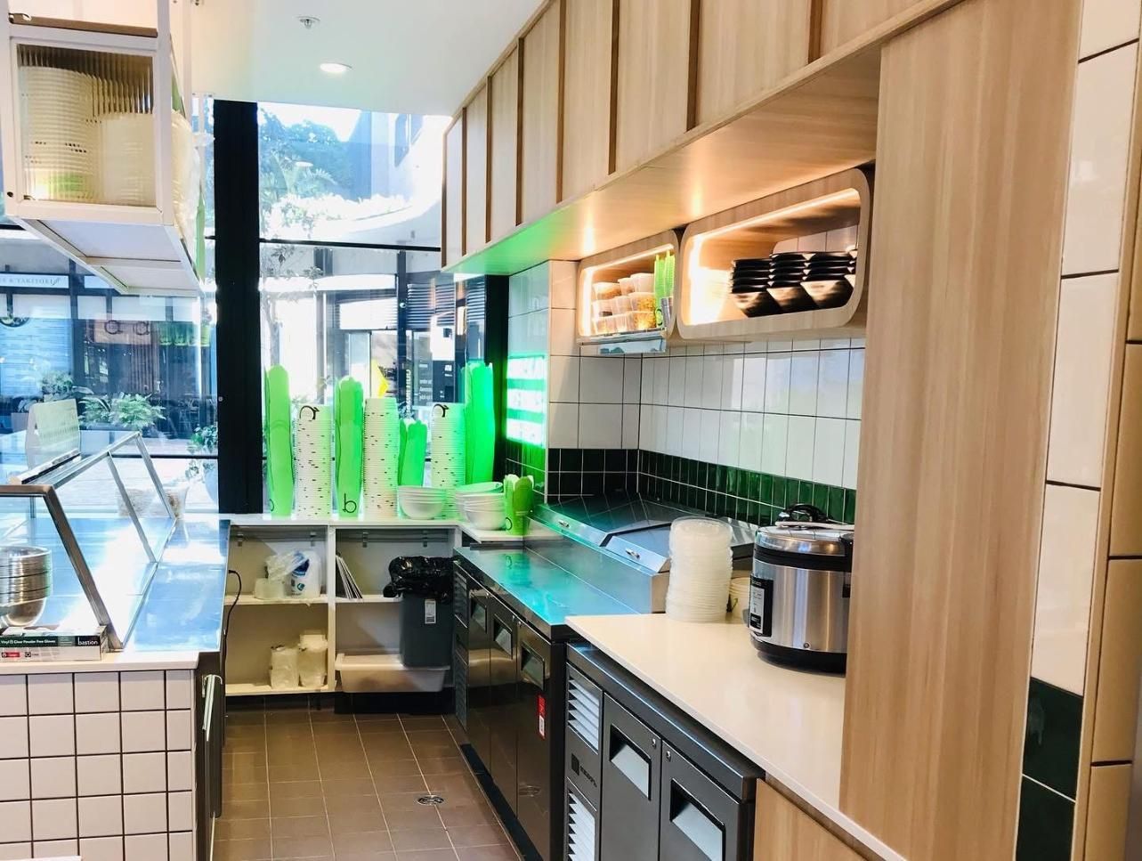 A Kitchen in a Restaurant With Green Cups on the Counter — Nyon Shopfitters in Morisset, NSW