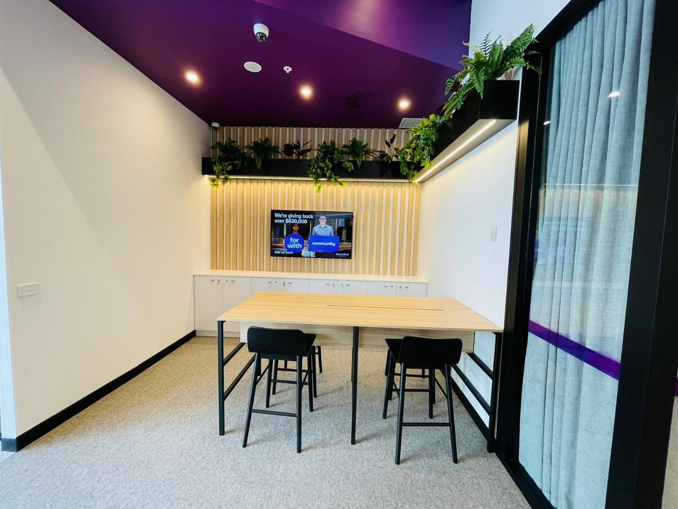 A Room With a Table and Chairs and a Television on the Wall — Nyon Shopfitters in Morisset, NSW