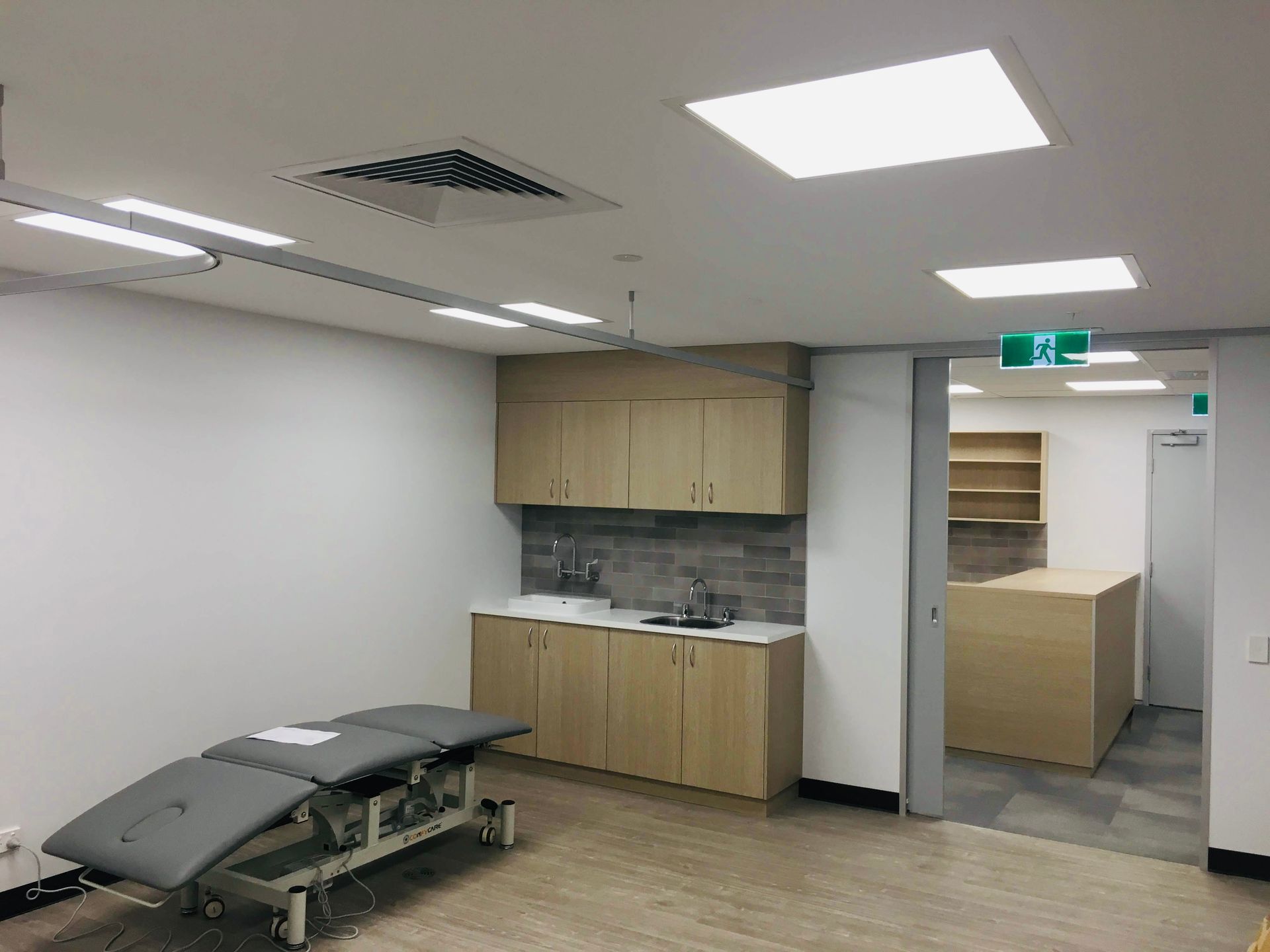 A Consultation Room With Wooden Cabinets — Nyon Shopfitters in Morisset, NSW