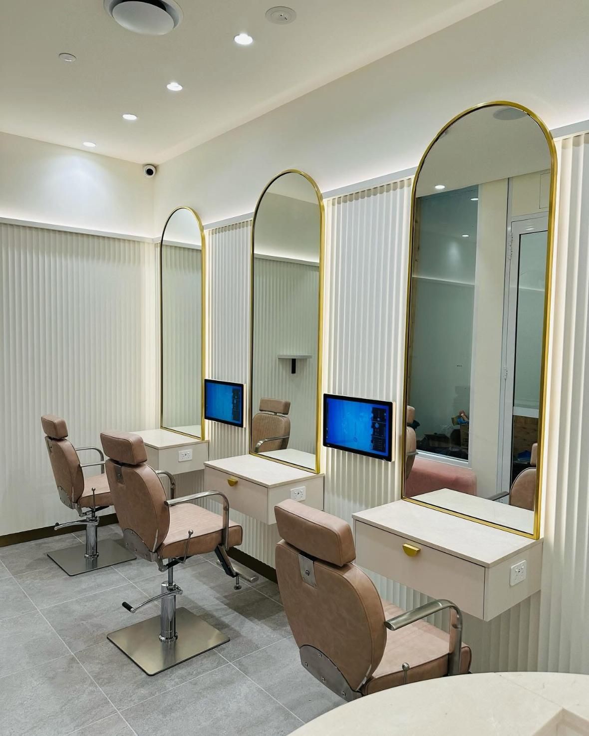 A Room With a Lot of Mirrors and Chairs in It — Nyon Shopfitters in Morisset, NSW
