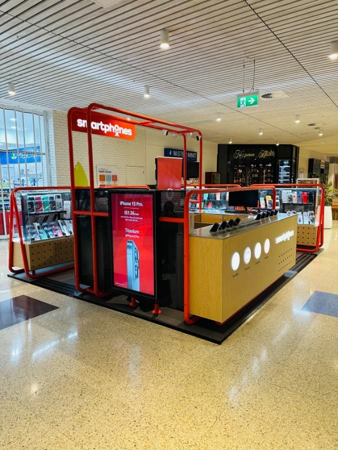A Kiosk in a Mall With a Red Sign That Says Smartphones on It — Nyon Shopfitters in Morisset, NSW