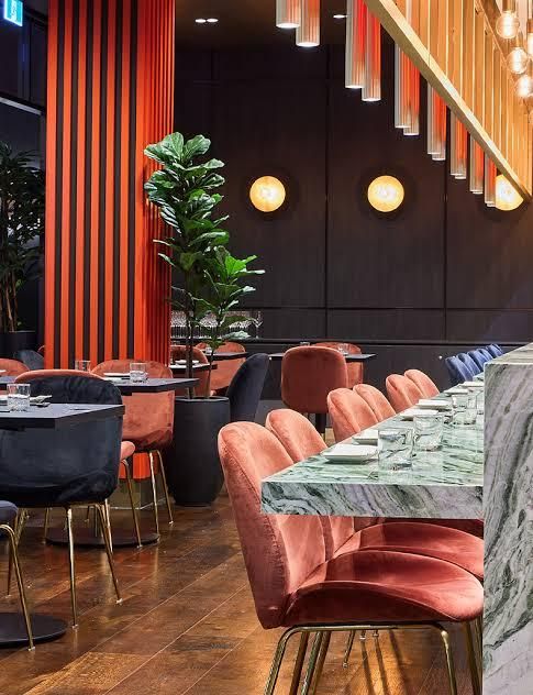 A Restaurant With Tables and Chairs and a Plant — Nyon Shopfitters in Morisset, NSW