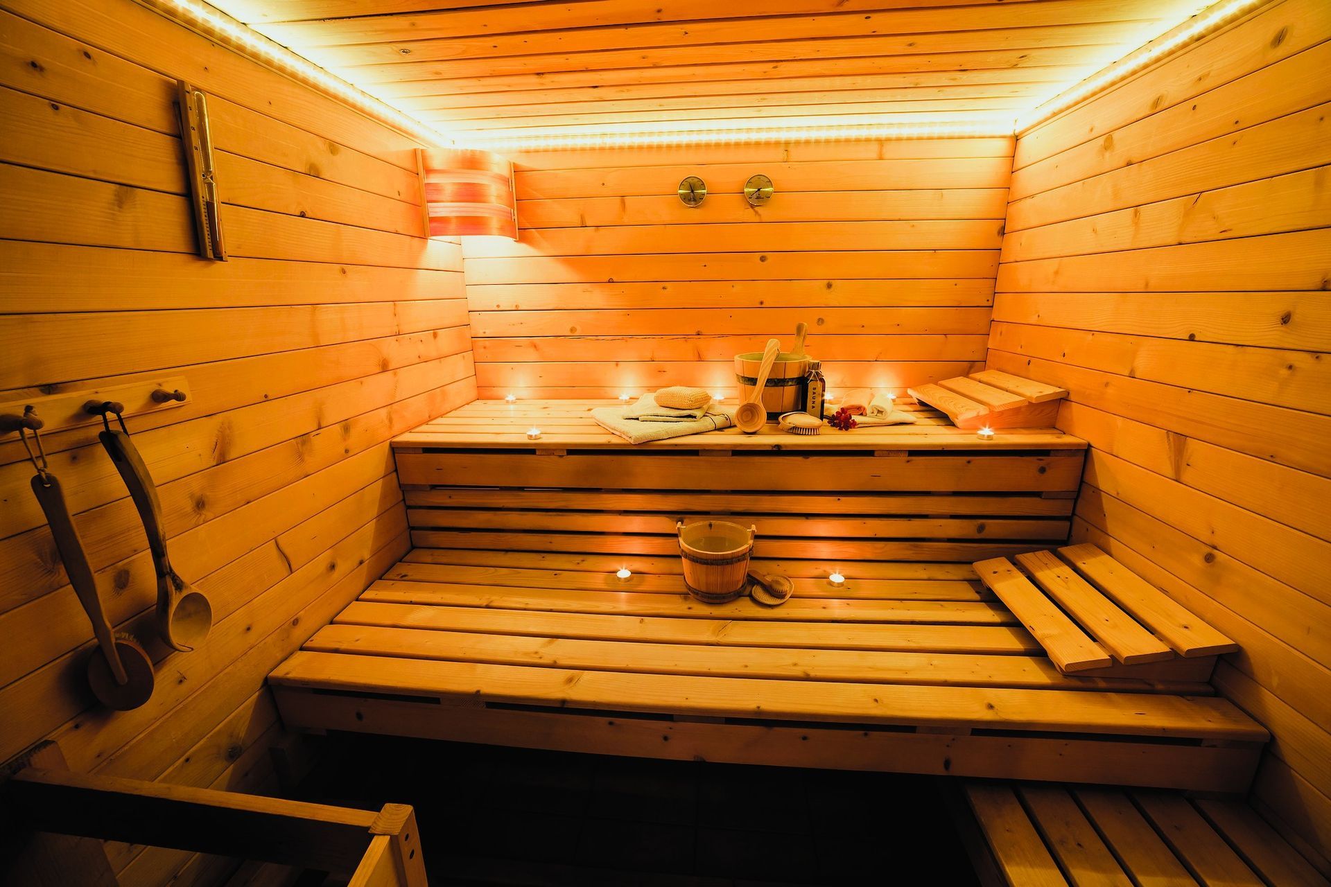 Cozy basement sauna with warm lighting and wooden benches
