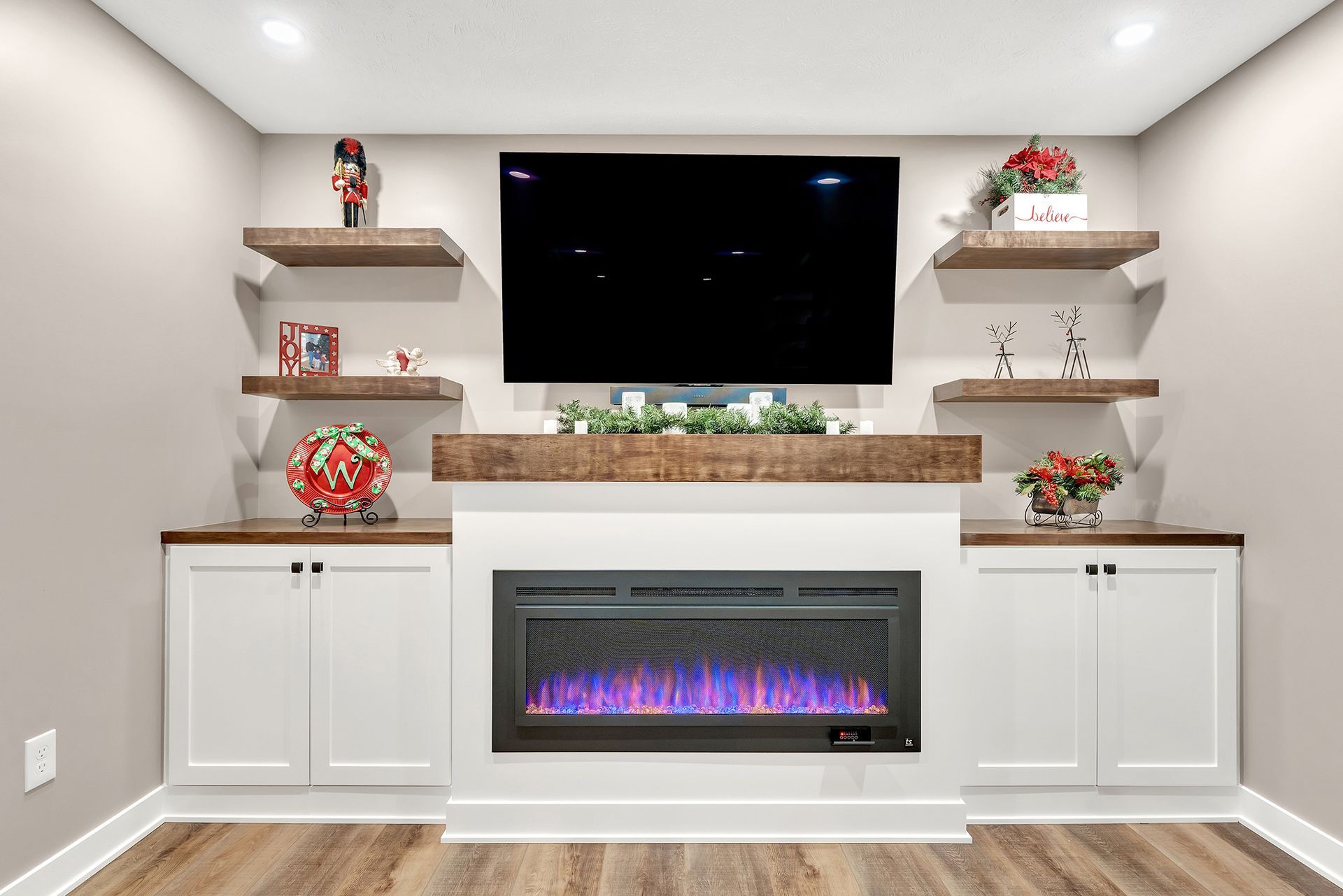 A living room with a fireplace and a flat screen tv.