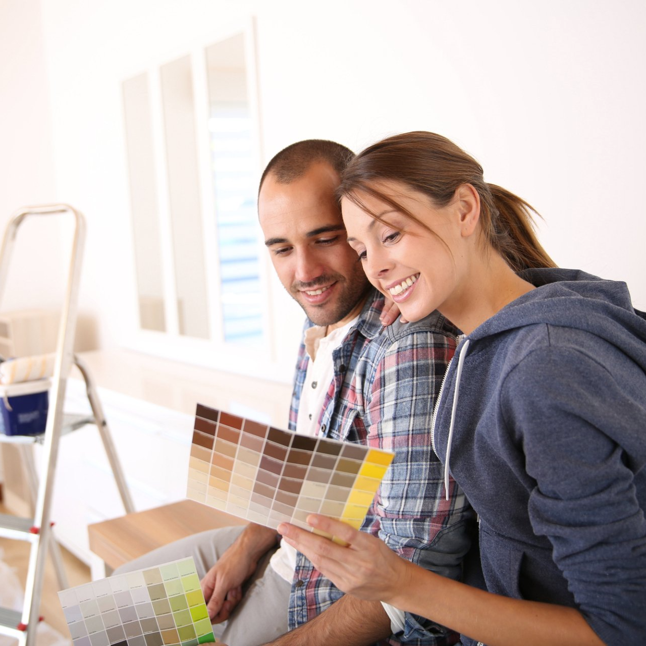 A man and a woman are looking at a color palette