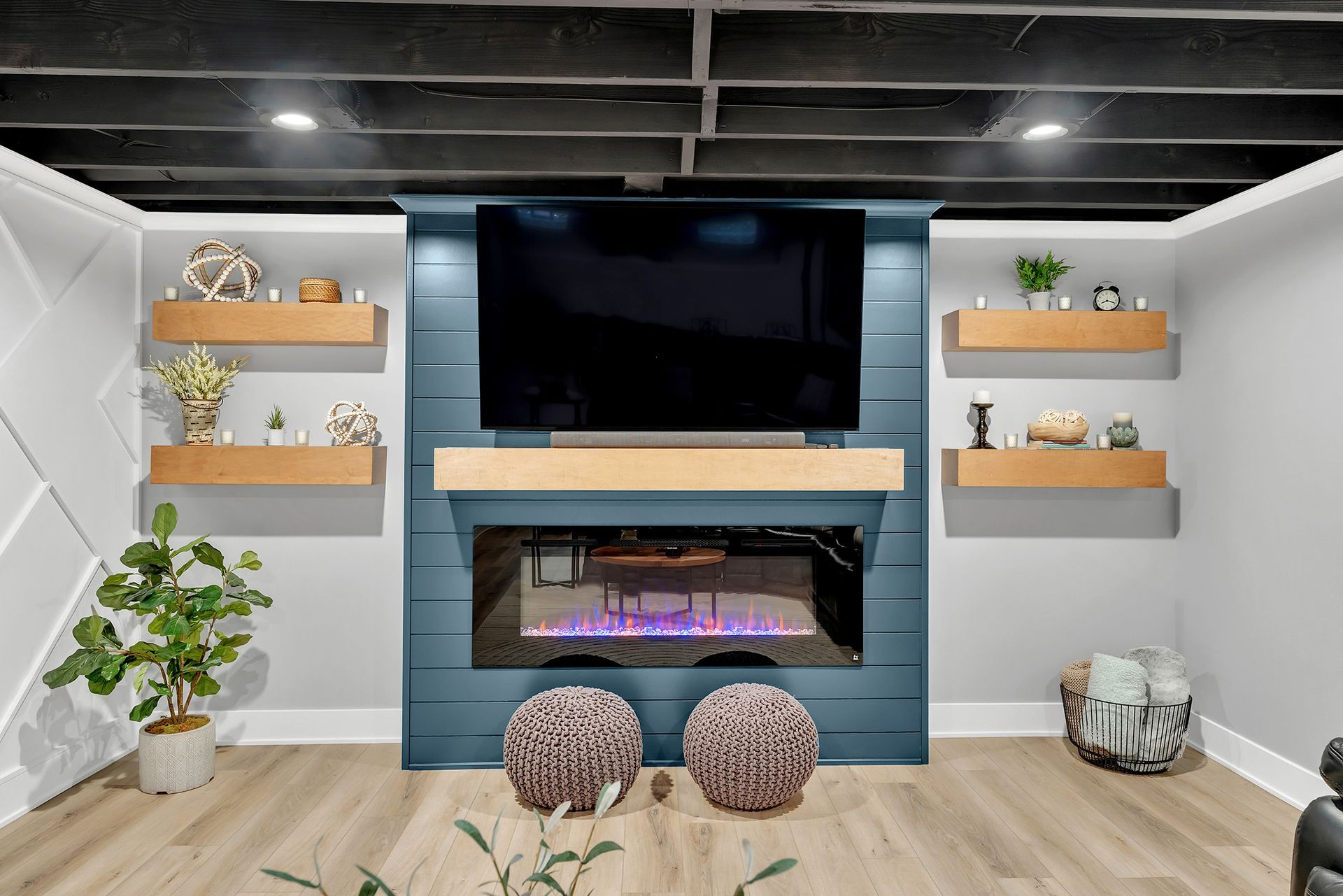 A living room with a fireplace and a flat screen tv.