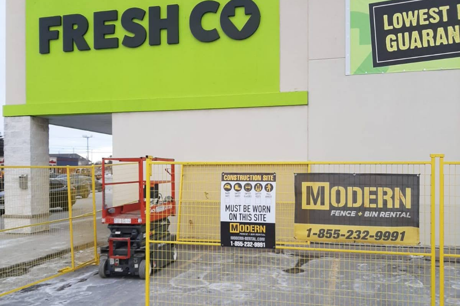 A fresh co store with a modern fence around it