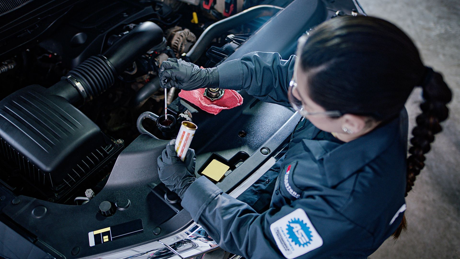 Service technician repairing a car AC system.