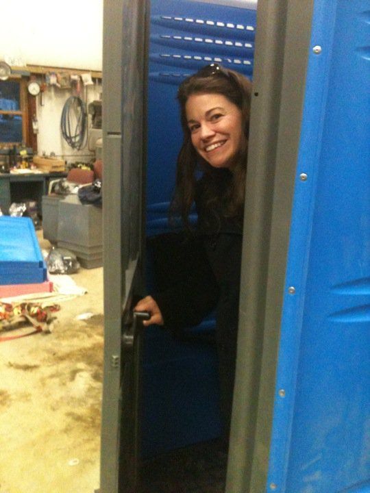 Woman exiting portable toilet in Rochester, NH