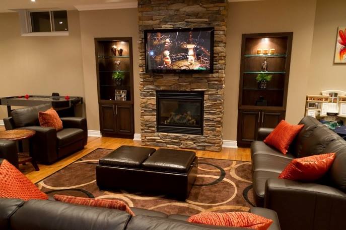 A living room with a fireplace and a flat screen tv