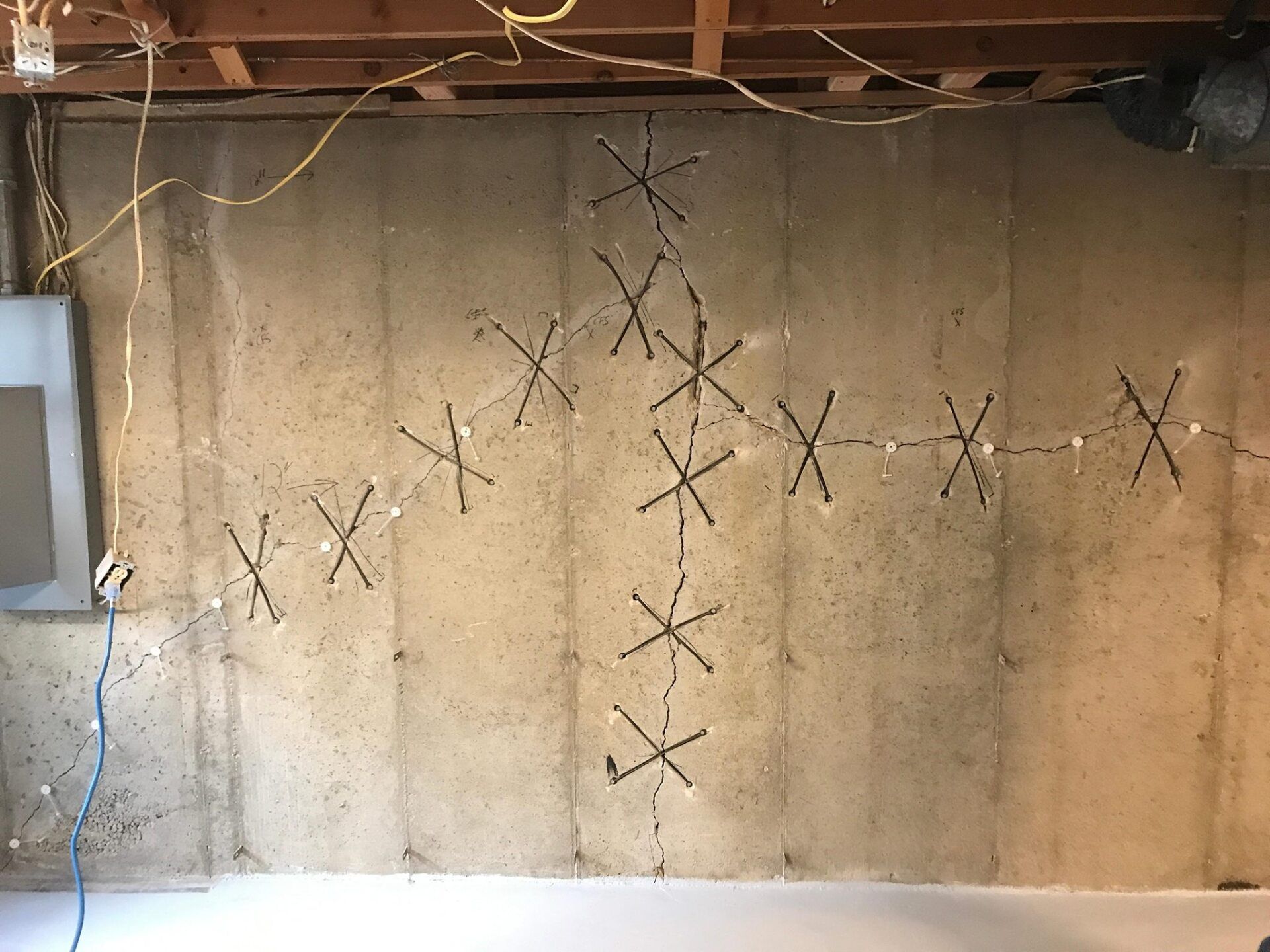 A concrete wall with a bunch of x 's on it