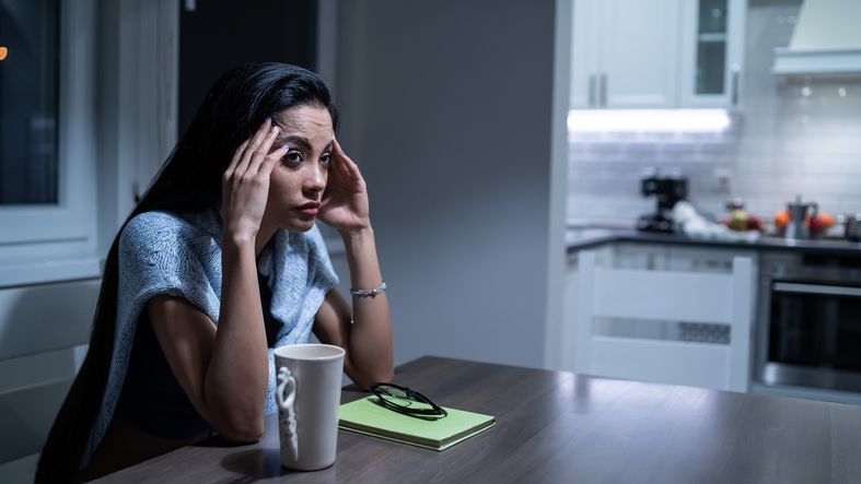 woman with her head in her hands facing foreclosure