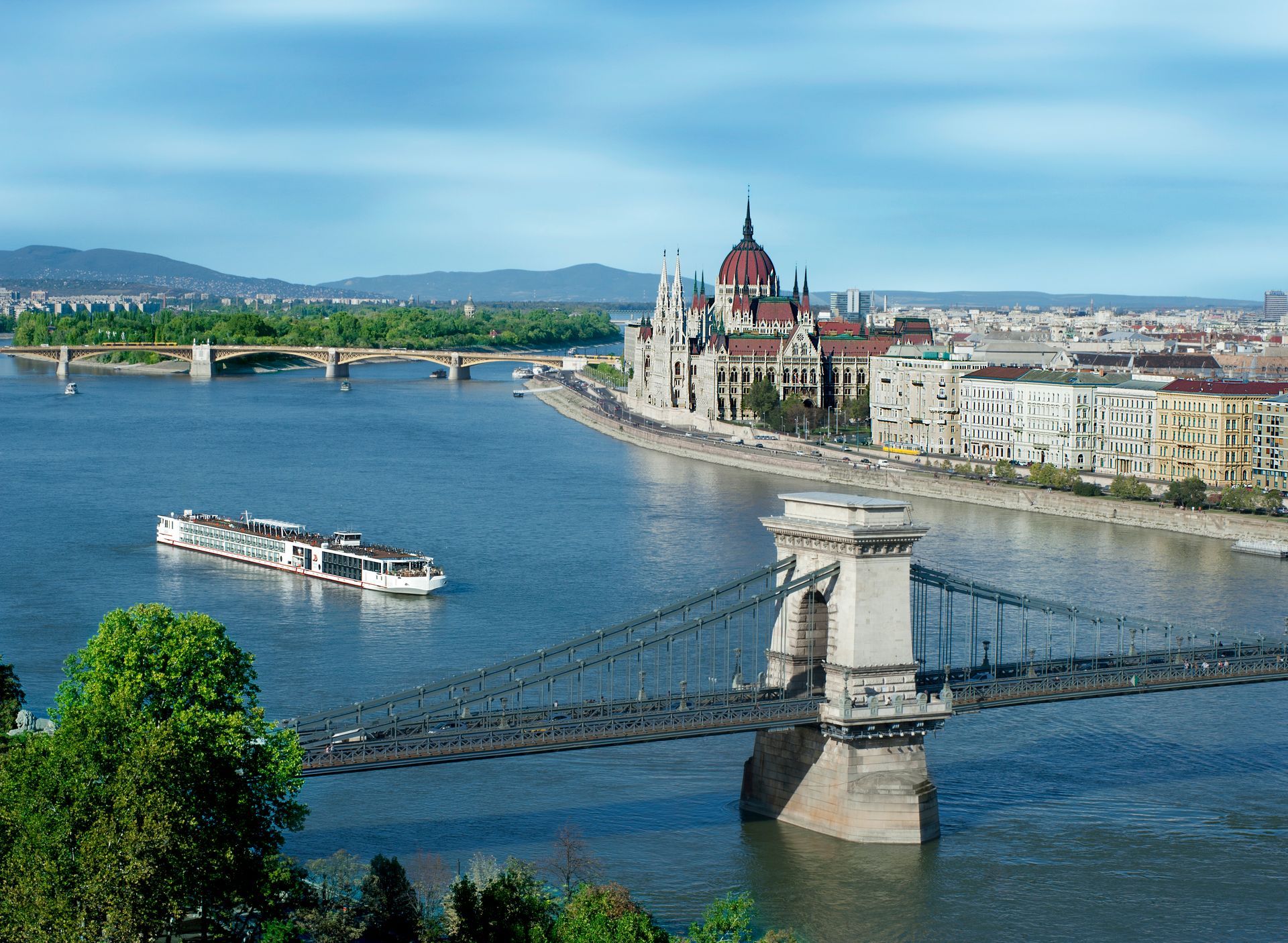 A bridge over a river with a city in the background